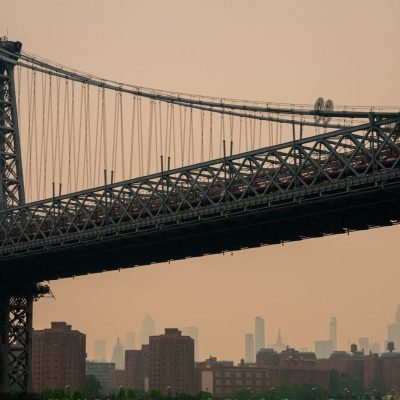 Wildfires force thousands to evacuate as smoke darkens skies over major cities
